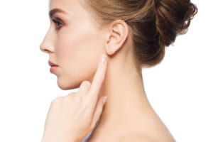 woman pointing to ear